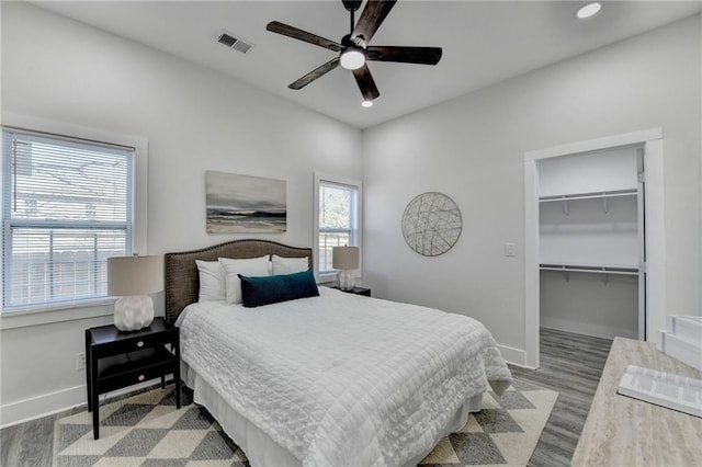 543 Paines Ave NW, Atlanta, GA 30318 - bedroom featuring visible vents, a spacious closet, baseboards, and wood finished floors