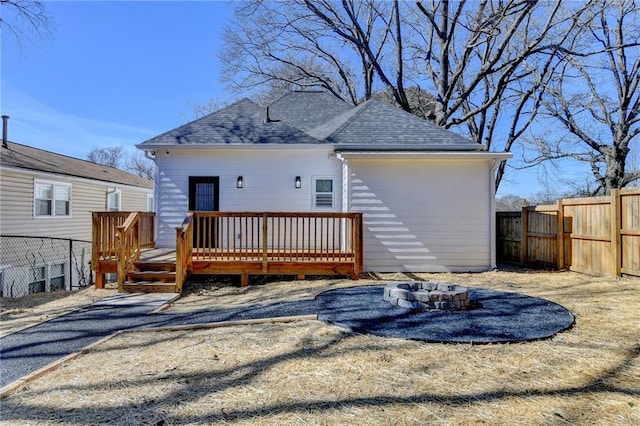 543 Paines Ave NW, Atlanta, GA 30318 - rear view of house featuring a fenced backyard, a fire pit, a wooden deck, and roof with shingles