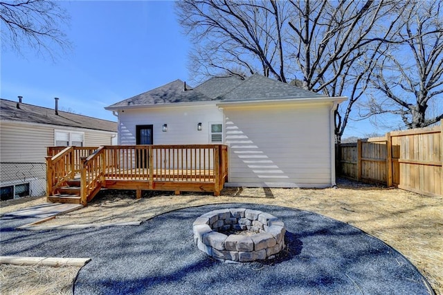 543 Paines Ave NW, Atlanta, GA 30318 - back of house featuring a fire pit, a deck, roof with shingles, and a fenced backyard
