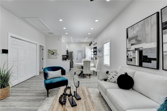 543 Paines Ave NW, Atlanta, GA 30318 - living room with light wood-style flooring, visible vents, attic access, and recessed lighting