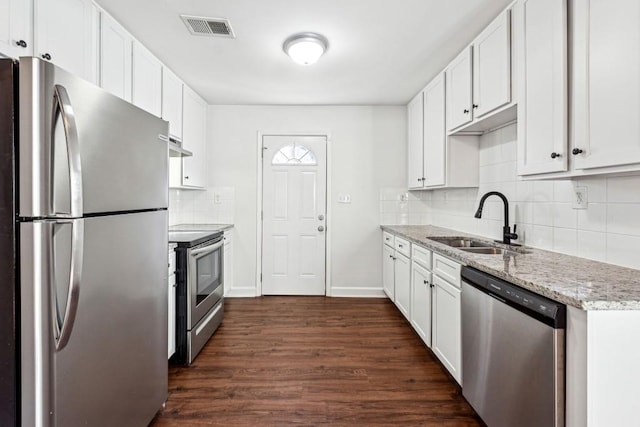 kitchen featuring light stone counters, appliances with stainless steel finishes, sink, and white cabinets