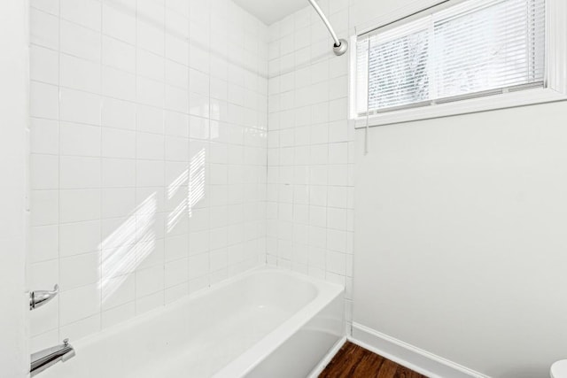 bathroom with tiled shower / bath combo and wood-type flooring