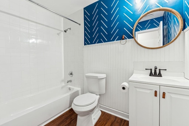 full bathroom with vanity, hardwood / wood-style floors, tiled shower / bath combo, and toilet