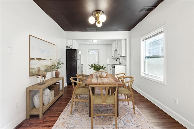 dining space with dark hardwood / wood-style floors