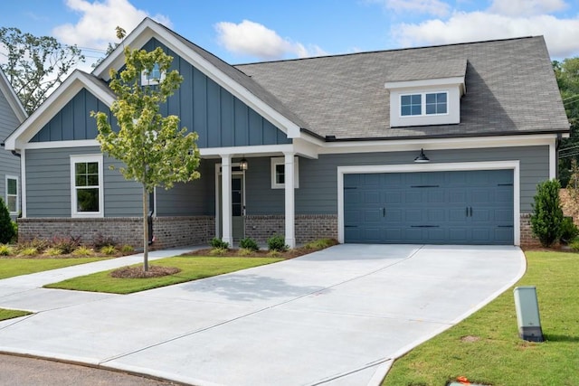 craftsman house with a front lawn and a garage