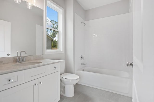 full bathroom featuring tile patterned flooring, toilet, vanity, and tiled shower / bath