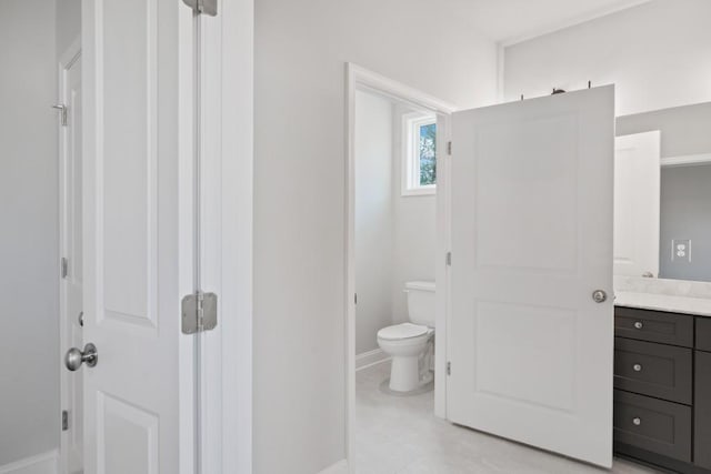 bathroom featuring toilet and vanity