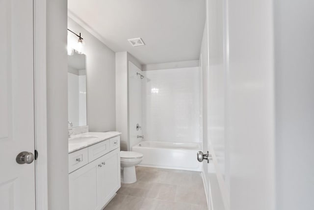 full bathroom with toilet, tile patterned floors, vanity, and tiled shower / bath