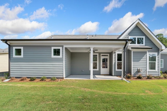 back of property featuring a patio, a lawn, and ceiling fan