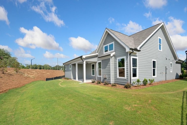 rear view of property with a yard