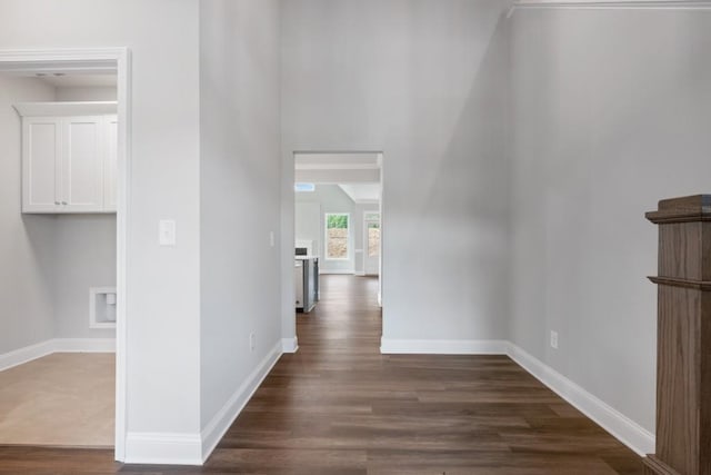 hallway with dark hardwood / wood-style flooring