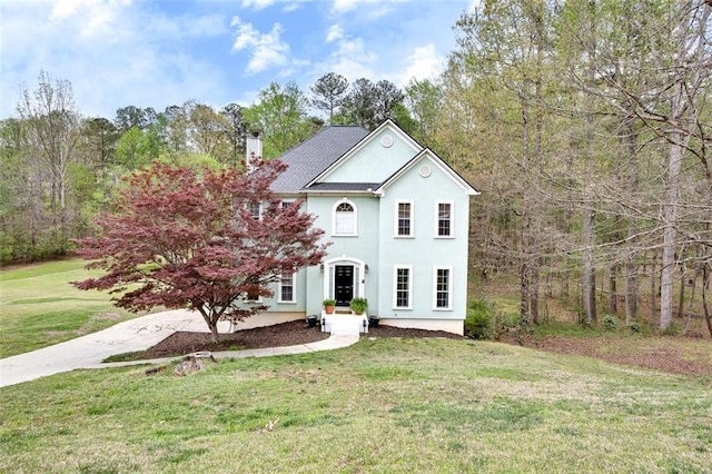1772 Brittany Chase NW, Kennesaw, GA 30152 - view of front facade with a chimney, stucco siding, and a front lawn
