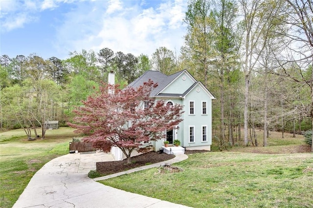 1772 Brittany Chase NW, Kennesaw, GA 30152 - view of front facade featuring a front yard, a chimney, driveway, and stucco siding