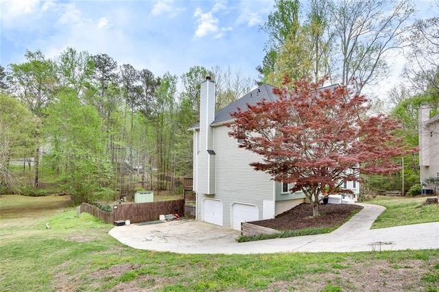 1772 Brittany Chase NW, Kennesaw, GA 30152 - view of home's exterior featuring an attached garage, a chimney, concrete driveway, and a lawn