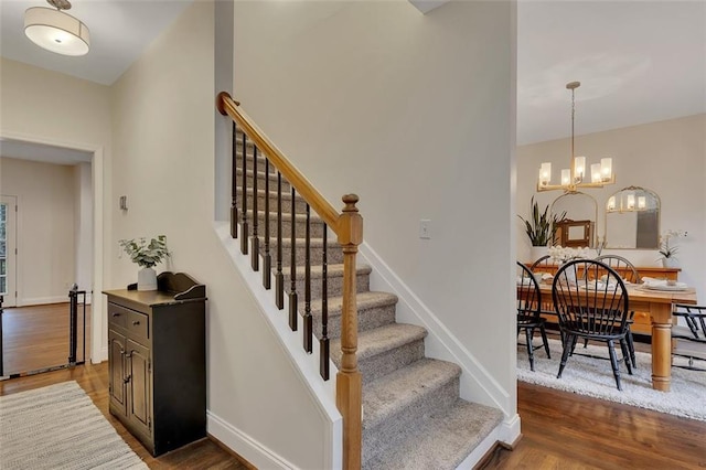 1772 Brittany Chase NW, Kennesaw, GA 30152 - stairs featuring wood finished floors, a chandelier, and baseboards