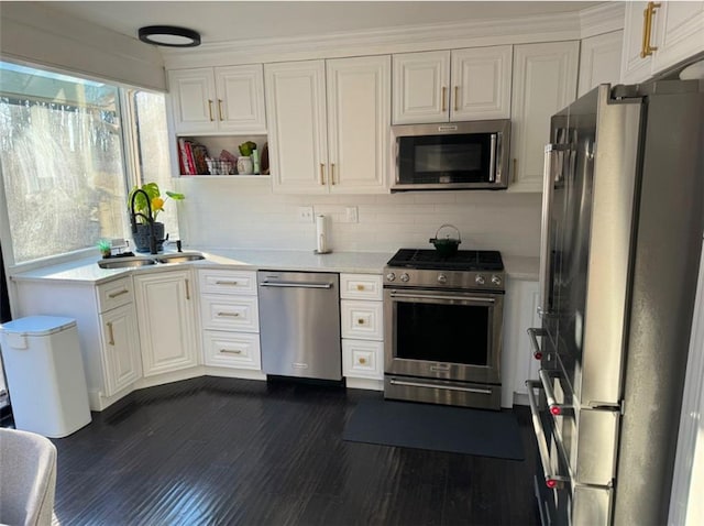 kitchen featuring decorative backsplash, sink, white cabinets, and stainless steel appliances