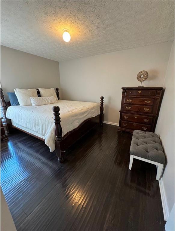 bedroom featuring dark hardwood / wood-style floors and a textured ceiling