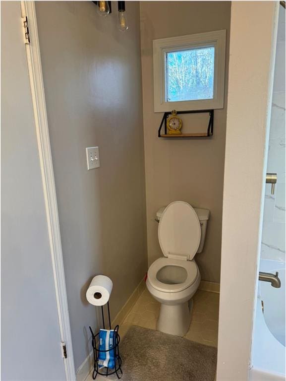 bathroom featuring toilet and tile patterned floors