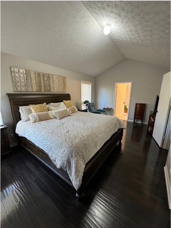 bedroom with ensuite bathroom, dark hardwood / wood-style floors, a textured ceiling, and lofted ceiling