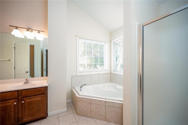 full bath featuring a stall shower, vaulted ceiling, vanity, tile patterned flooring, and a bath