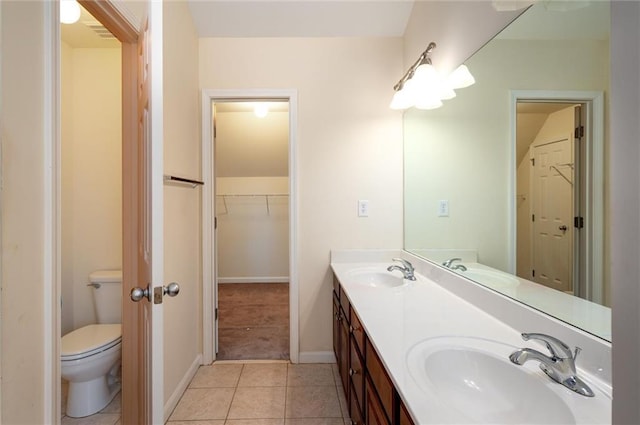 bathroom with a sink, toilet, and tile patterned floors