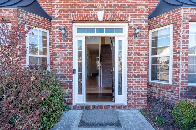 doorway to property with brick siding