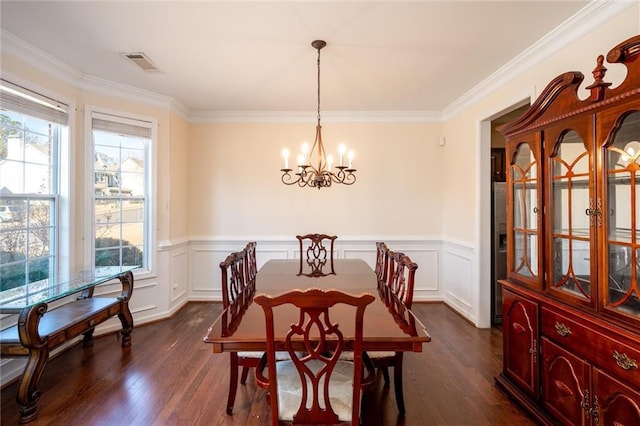 dining room with a chandelier, visible vents, dark wood finished floors, and ornamental molding