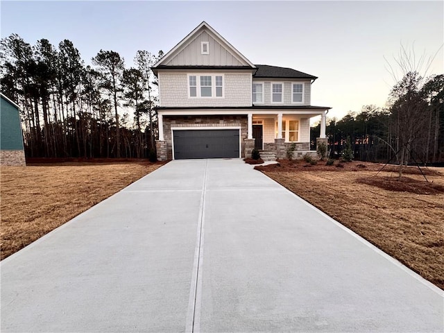 view of front facade featuring covered porch and a garage