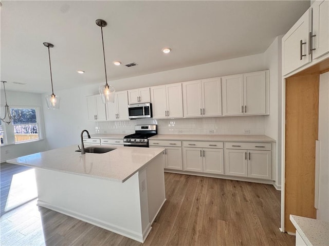 kitchen featuring white cabinetry, sink, and appliances with stainless steel finishes