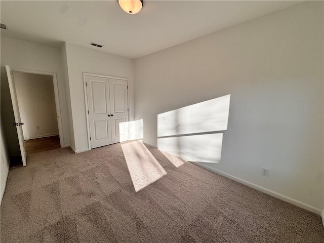 unfurnished bedroom with carpet flooring and a closet