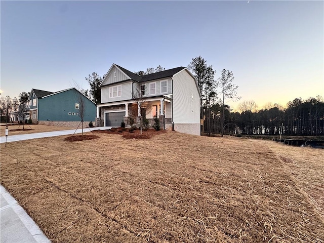 view of front of property with a lawn and a garage