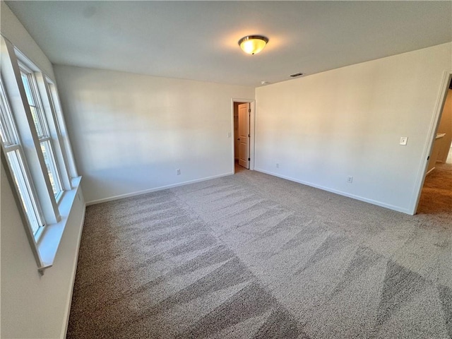 empty room featuring carpet floors and a healthy amount of sunlight