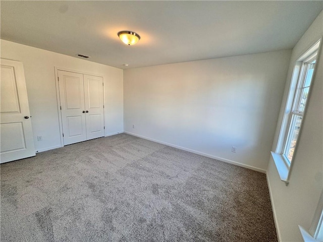 unfurnished bedroom with carpet and a closet