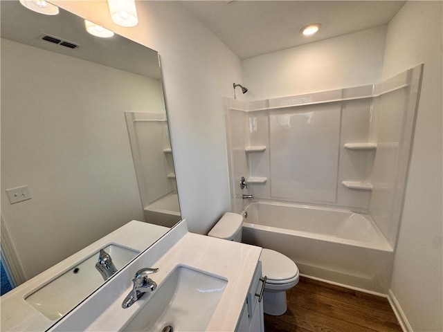 full bathroom with vanity, hardwood / wood-style flooring, toilet, and shower / bathtub combination