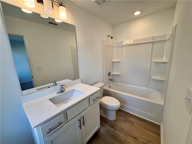 full bathroom with shower / bathing tub combination, wood-type flooring, vanity, and toilet