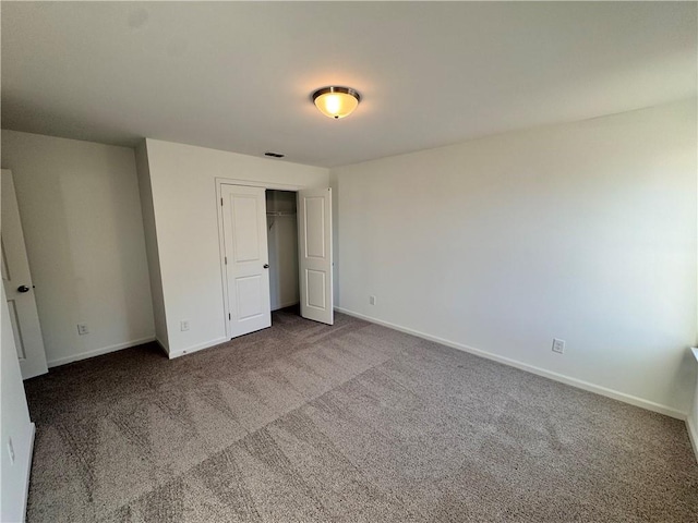 unfurnished bedroom with carpet floors and a closet