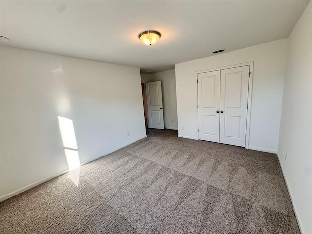 unfurnished bedroom with carpet floors and a closet