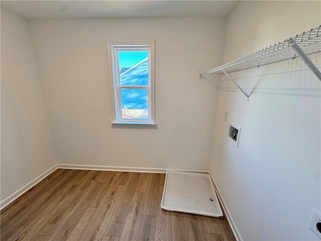 clothes washing area with washer hookup and wood-type flooring