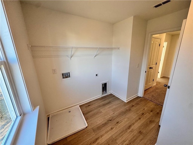 clothes washing area with hookup for a washing machine, electric dryer hookup, and wood-type flooring