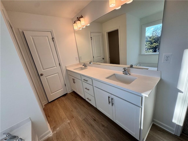 bathroom featuring a bathtub, vanity, and hardwood / wood-style flooring