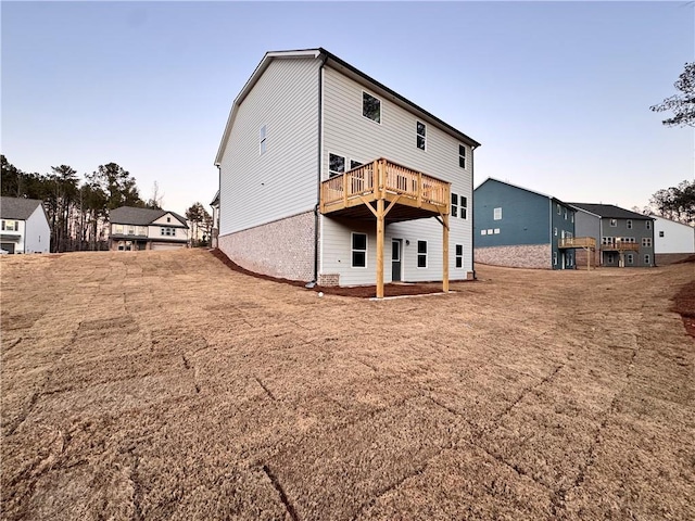 rear view of house featuring a wooden deck