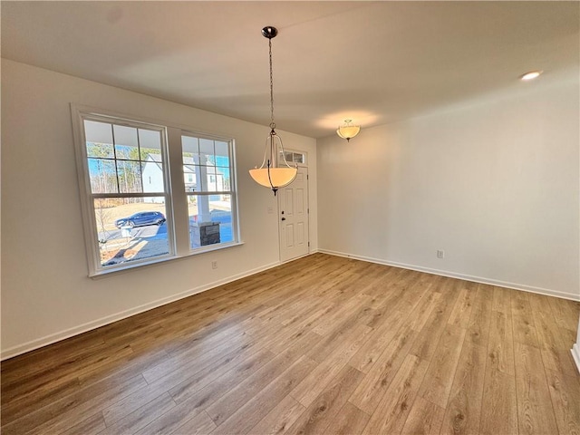 unfurnished dining area with light wood-type flooring