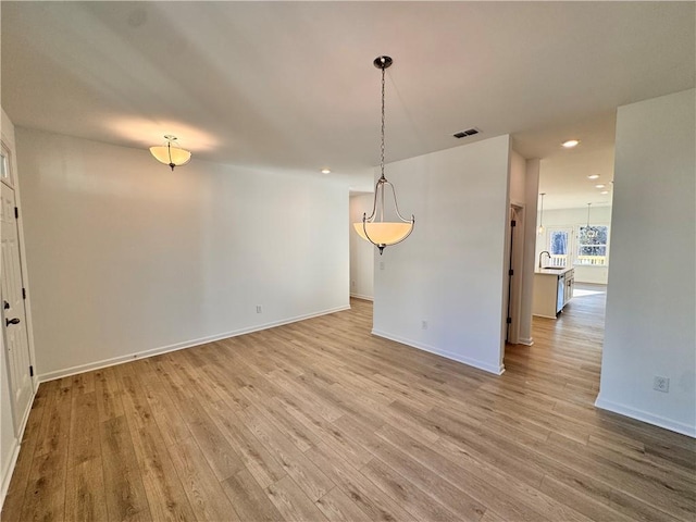 unfurnished dining area with light wood-type flooring