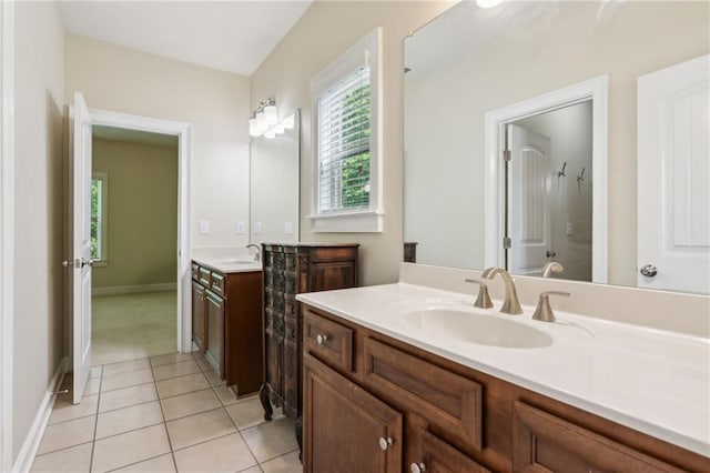 2434 Soft Maple St, Atlanta, GA 30360 - bathroom featuring tile patterned floors, two vanities, and baseboards