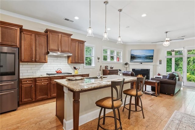 2434 Soft Maple St, Atlanta, GA 30360 - kitchen with a sink, appliances with stainless steel finishes, under cabinet range hood, light wood finished floors, and light stone countertops