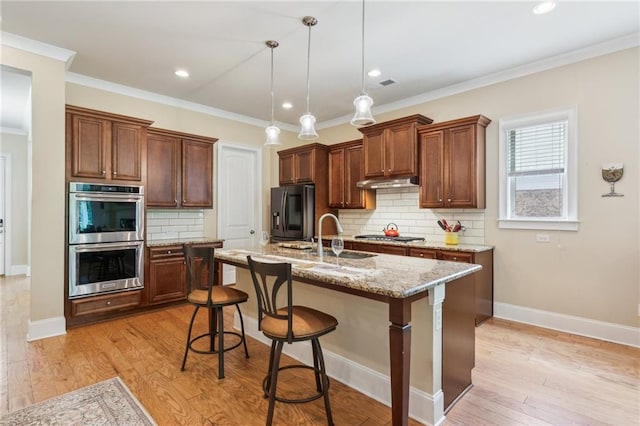 2434 Soft Maple St, Atlanta, GA 30360 - kitchen with stainless steel appliances, a breakfast bar, tasteful backsplash, hanging light fixtures, and light stone counters