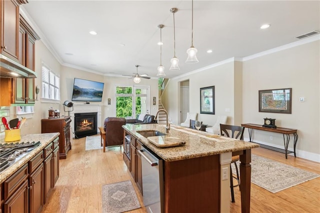 2434 Soft Maple St, Atlanta, GA 30360 - kitchen featuring a sink, stainless steel appliances, a kitchen breakfast bar, ornamental molding, and light wood-type flooring