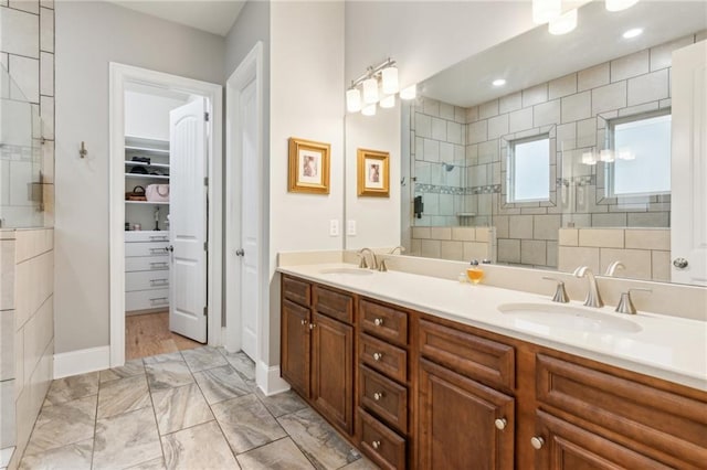 2434 Soft Maple St, Atlanta, GA 30360 - bathroom featuring a tile shower, double vanity, a spacious closet, marble look tiles, and baseboards