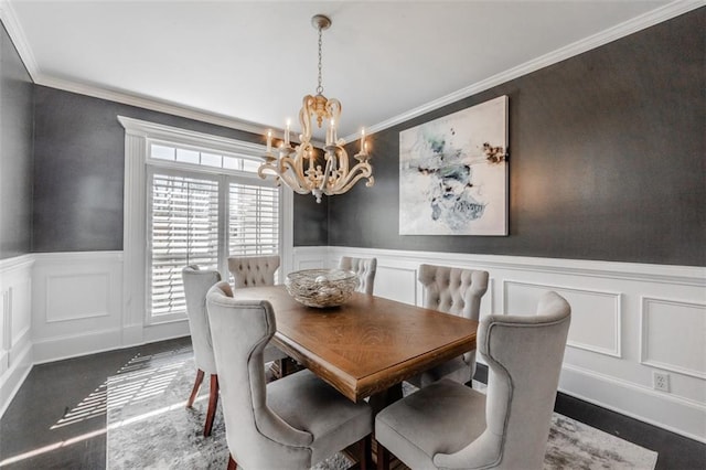 dining area featuring crown molding and an inviting chandelier