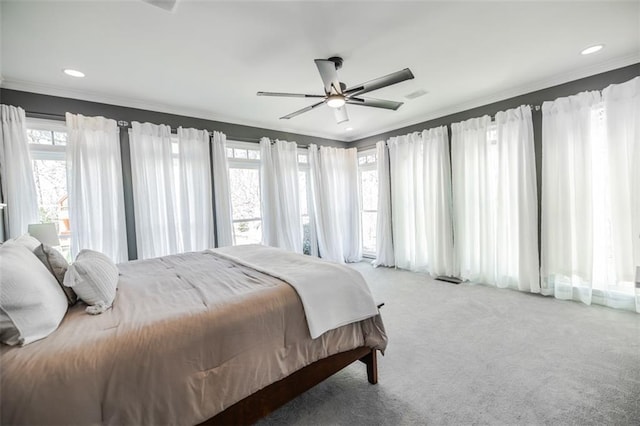 bedroom with crown molding, ceiling fan, and carpet floors